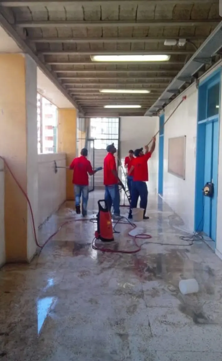 Pressure-washing a school hallway