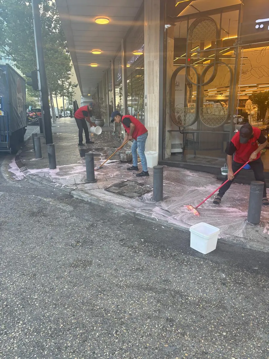 Washing the pavement in front of a restaurant