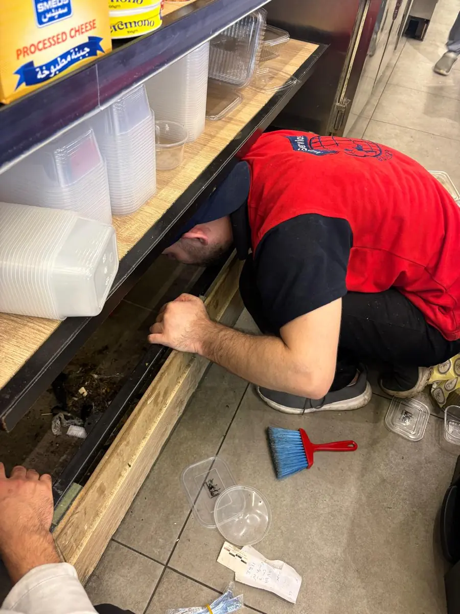 Deep cleaning under a restaurant counter